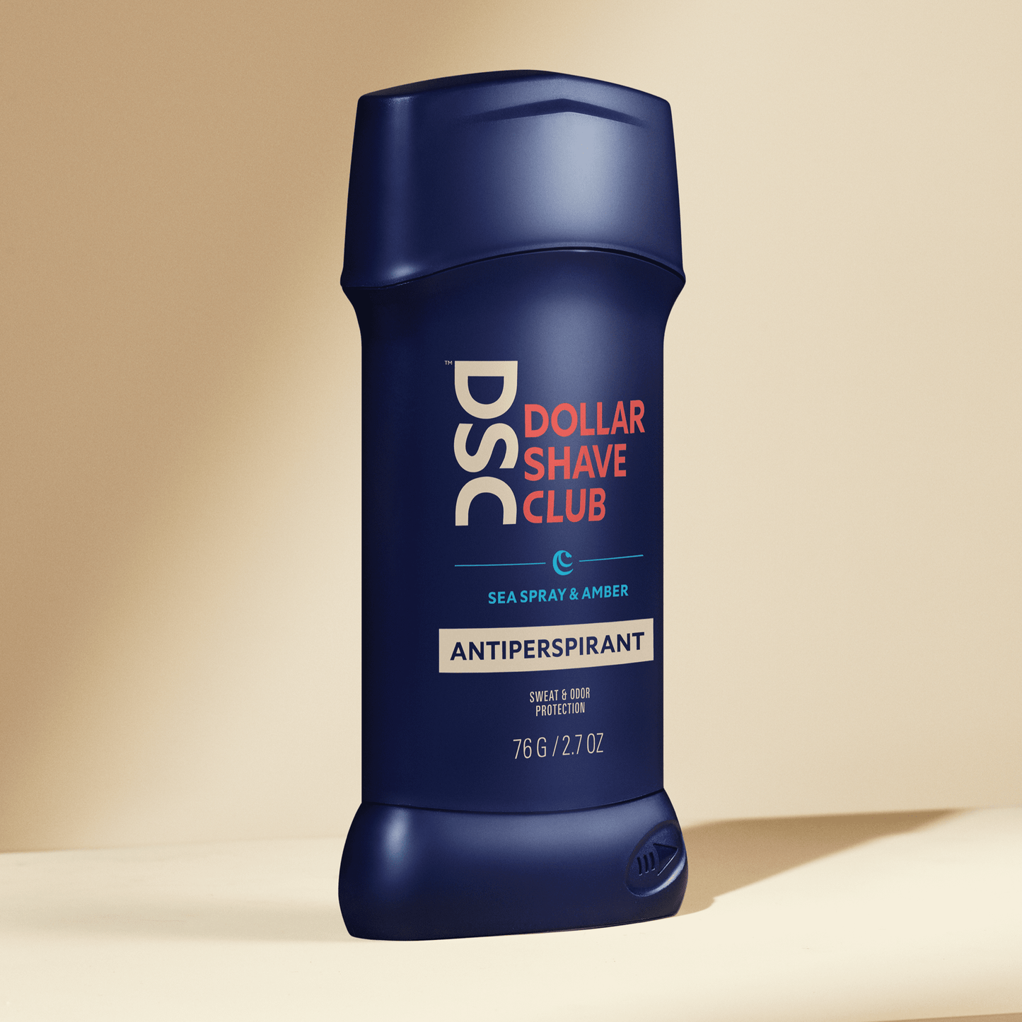 Dollar Shave Club Antiperspirant Sea Spray Amber against tan backdrop.