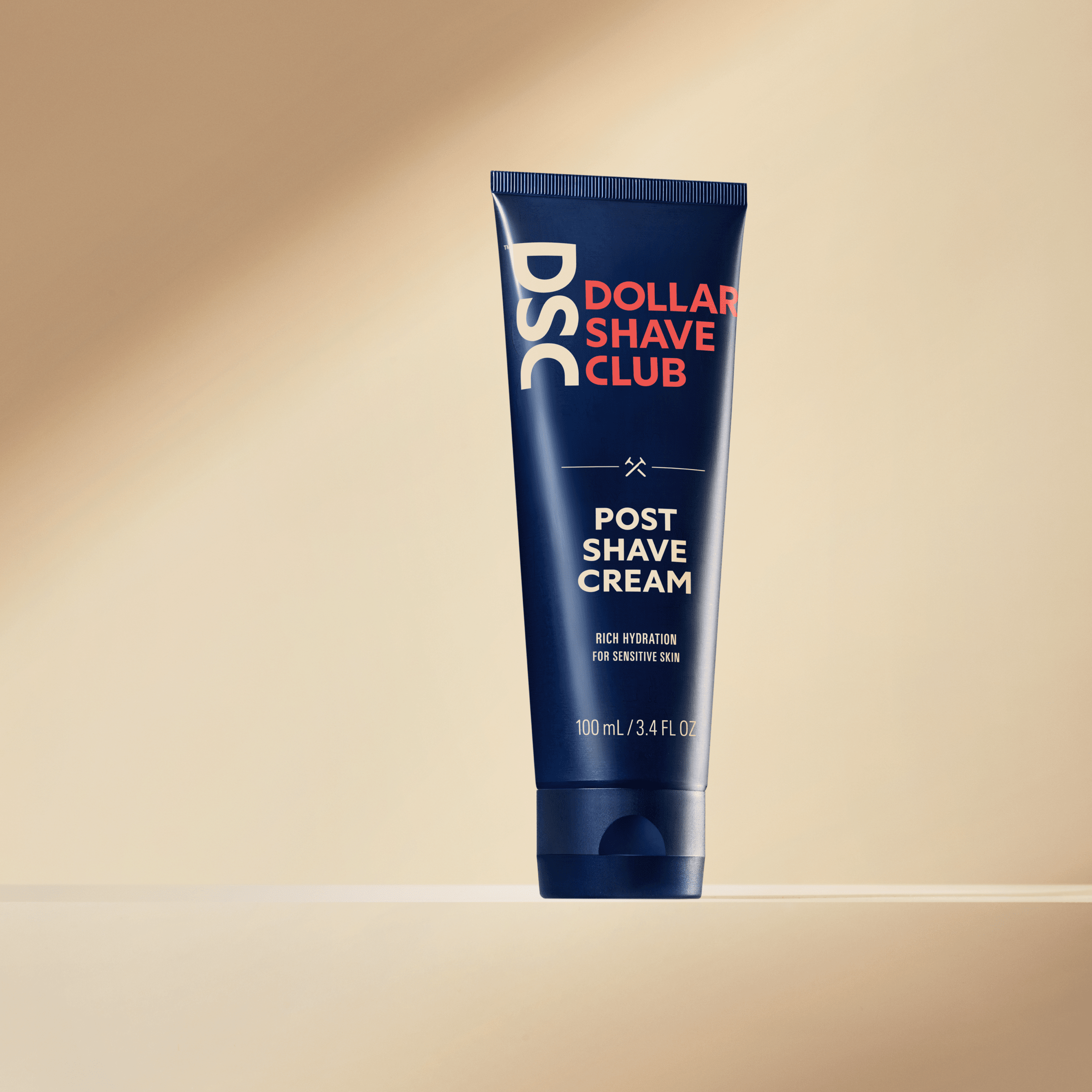 Dollar Shave Club Shave Cream product image against tan backdrop.